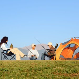 Family out camping and preparing fishing rods