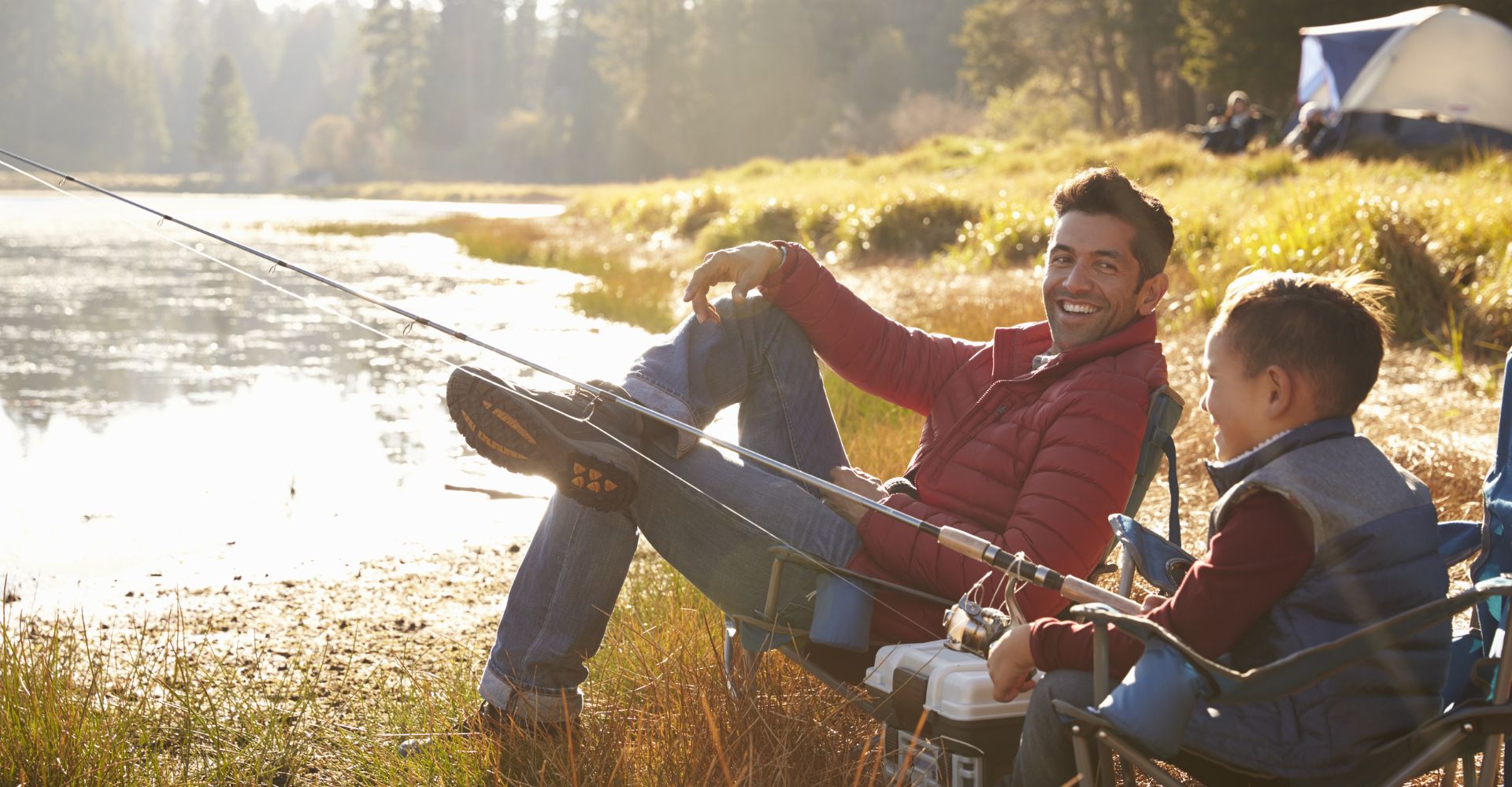 Father and son sitting together while fishing